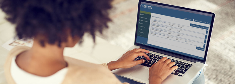 Lady checking Guardian Online Banking on her laptop